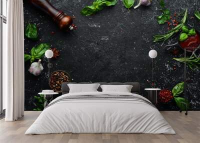 Black culinary background with spices and vegetables on the table. Top view. Free space for your text. Wall mural