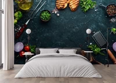 Black food background. Vegetables and spices on black background. Top view. Free space for your text. Wall mural