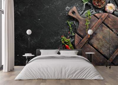 Black kitchen banner with board, spices and herbs. Top view. Free space for text. Wall mural