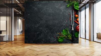 black stone cooking background. spices and vegetables. top view. free space for your text. Wall mural