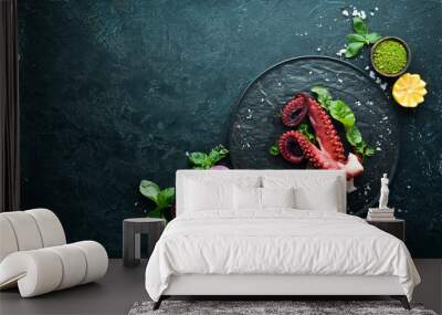 Boiled octopus tentacles on a stone plate. Seafood. Top view. Free copy space. Wall mural