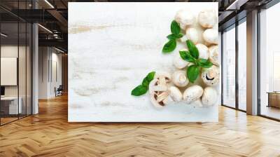 Champignons on a white cooking table. Mushrooms Top view. Free space for text. Wall mural