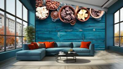 Chocolate, cocoa and cocoa beans on a blue wooden background. Top view. Free copy space. Wall mural