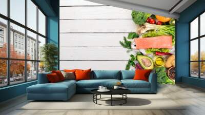 Fish and fresh vegetables. Healthy food. On a white wooden background. Healthy food. Top view. Copy space. Wall mural