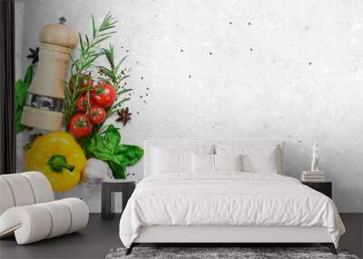 Food background. Vegetables, spices and pepper mill on a gray stone background. Top view. Free space for text. Wall mural