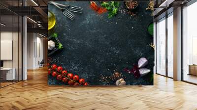 Food banner. Spices, vegetables and herbs on a black stone background. Top view. free space for your text. Rustic style. Wall mural