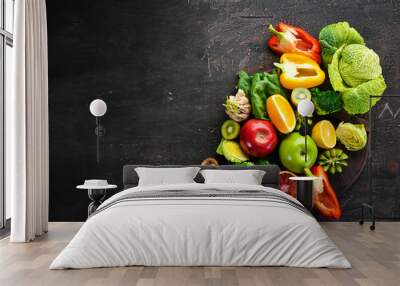 Food containing vitamin C: Orange, lemon, apple, rose, garlic, broccoli, apple, kiwi, spinach. Top view. On a brown background. Wall mural