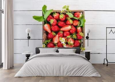 Fresh strawberries in a wooden box. On a wooden background. Top view. Copy space. Wall mural