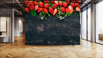 Fresh strawberries. On a black wooden background. Top view. Copy space. Wall mural