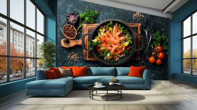 Fried shrimp with vegetables in a frying pan. Seafood. Top view. Free space for your text. Wall mural