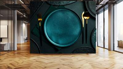 Gold knives and forks on a black background, empty black plate. Beautiful gold cutlery. View from above. Wall mural