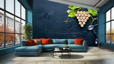 Grape motive. A bottle and a glass of wine and grape leaves. Top view. Free space. Wall mural