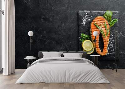 Grilled salmon steak on a stone plate. On an old background. Top view. Free copy space. Wall mural