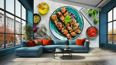 kebabs - grilled meat skewers, shish kebab with vegetables on a plate. on a concrete old table. top  Wall mural