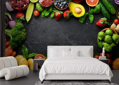 Organic vegan food: fresh vegetables and fruits are good for health. On a black stone background. Wall mural