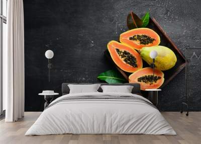 Papaya fruit on a wooden background. Tropical Fruits. Top view. Free space for text. Wall mural