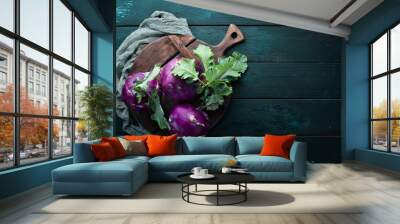 Purple kohlrabi cabbage. On a black background. Top view. Free space for your text. Wall mural