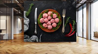 Raw meat balls. On a black stone background. Top view. Free copy space. Wall mural