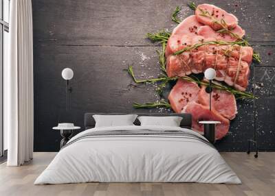 Raw meat Beef fillet with rosemary and spices on a black wooden background. Top view. Free space for text Wall mural