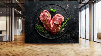 Raw Steak Ribeye. On a black stone table. Top view. Free space for your text. Wall mural