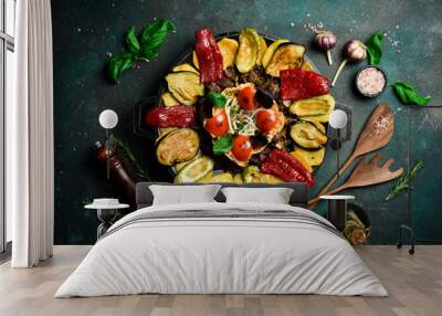 Saj - traditional Azerbaijani food. Lamb saj in a metal pan. Free space for text. On a dark background. Wall mural