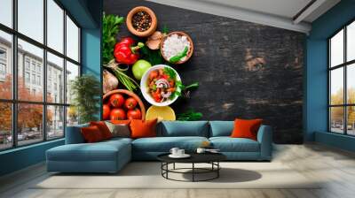 salsa sauce and ingredients. Latin American Mexican Traditional Sauce. Top view. On a black background. Free space for text. Wall mural