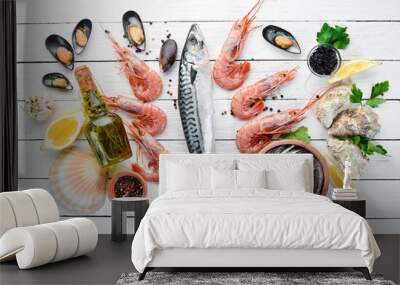 Seafood on a white wooden background. Fresh fish, shrimp, oysters and caviar. Top view. Free copy space. Wall mural