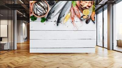 Seafood on a white wooden background. Fresh fish, shrimp, oysters and caviar. Top view. Free copy space. Wall mural