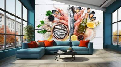 Seafood on a white wooden background. Fresh fish, shrimp, oysters and caviar. Top view. Free copy space. Wall mural