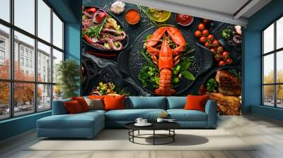 Set of seafood dishes. Fish, squid, octopus on a black stone background. Top view. Free space for your text. Wall mural