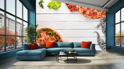 Set pizza. Italian cuisine. Top view. On a wooden background. Copy space. Wall mural