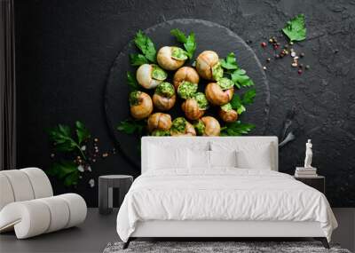 Snails baked with sauce. Baked snails with butter and spice. Top view. Free space for your text. Wall mural