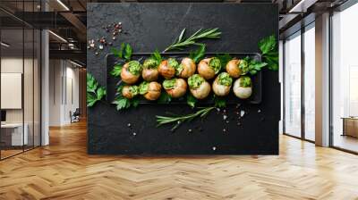 Snails baked with sauce. Baked snails with butter and spice. Top view. Free space for your text. Wall mural