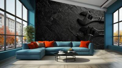 spanner on a black stone background. concept of repair or adjustment. Wall mural