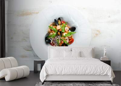 Traditional seafood pasta on a plate. Mussels, prawns, squid. Top view. Free copy space. Wall mural