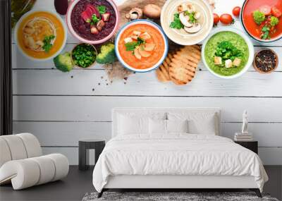 Variety of colorful vegetables cream soups. Concept of healthy eating or vegetarian food. Top view. Free copy space. Wall mural