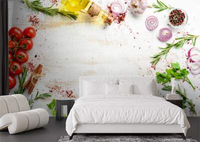 White wooden background of cooking. Spices and vegetables. Top view. Free space for your text. Wall mural