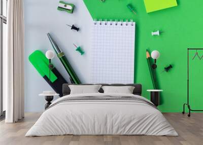 notebook and pencil isolated on white and green background with copy space Wall mural