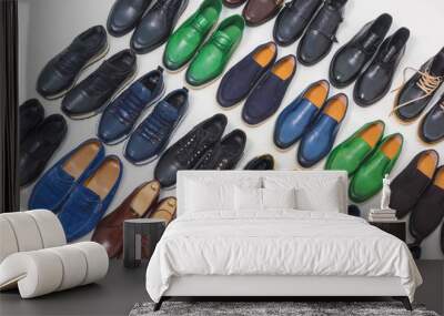 Multicolored men's shoes on a white background. A lot of men's shoes in a row. Types of male shoes. Boots, sneakers and shoes Wall mural