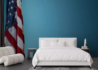 Tranquil blue backdrop with an American flag, reflecting Memorial Day reverence. Wall mural