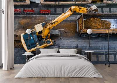 construction equipment excavates a city street to improve the wastewater infrastructure. Top View. Selective Focus Machine Wall mural