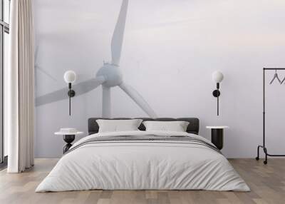 Windmills in the fog at sunrise. Wind turbine from aerial view. Sustainable development, environment friendly. Wall mural