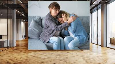 elderly mother hug crying adult daughter show support and care , supportive senior woman embrace cuddle grownup child feeling depressed, having life problems Wall mural