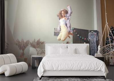 funny happy girl jumping and having fun in bed Wall mural