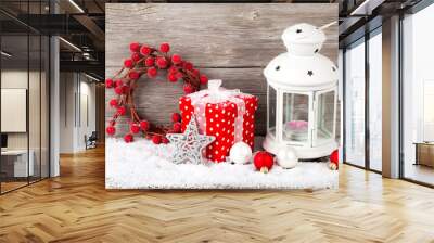 Burning lantern in the snow with christmas decoration, on wood b Wall mural