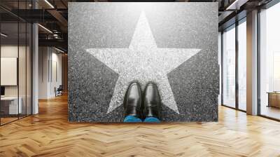 Success in business design concept. Businessman standing on street road background. Top view. Selfie of feet in black leather shoes and white star symbol on pathway floor. New talent or champion. Wall mural