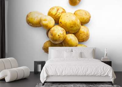 Closeup of a pile of fresh organic potatoes from the garden isolated on a transparent background with shadow from above, top view, png Wall mural