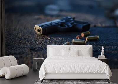 A pistol and shell casings lie on the asphalt, evidence of a crime Wall mural