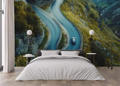 Car driving on a serpentine road. Curvy road surrounded by pine forest. Top view Wall mural