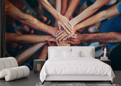 Diverse group of people joining hands together in a circle showing teamwork and unity Wall mural